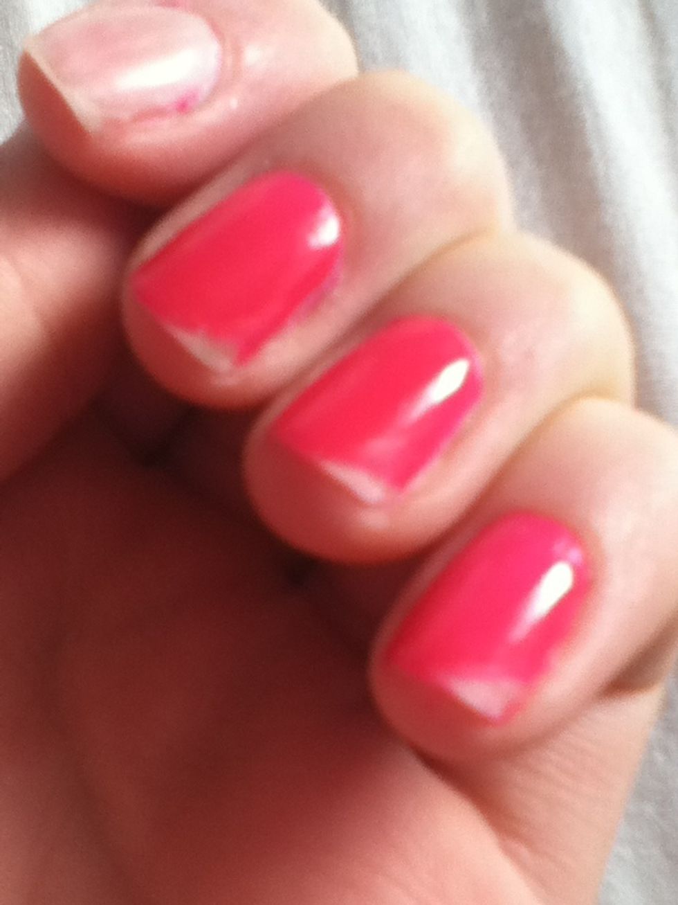 If you have a buffer, use it to smooth out the chipped part of the nail. If not just use a normal file gently