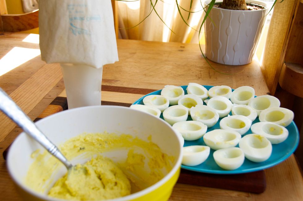 If you have a piping bag - GREAT! It makes it 1000 times easier to fill the egg whites. ** A little tip ** place the bag in a large glass, then fill it!