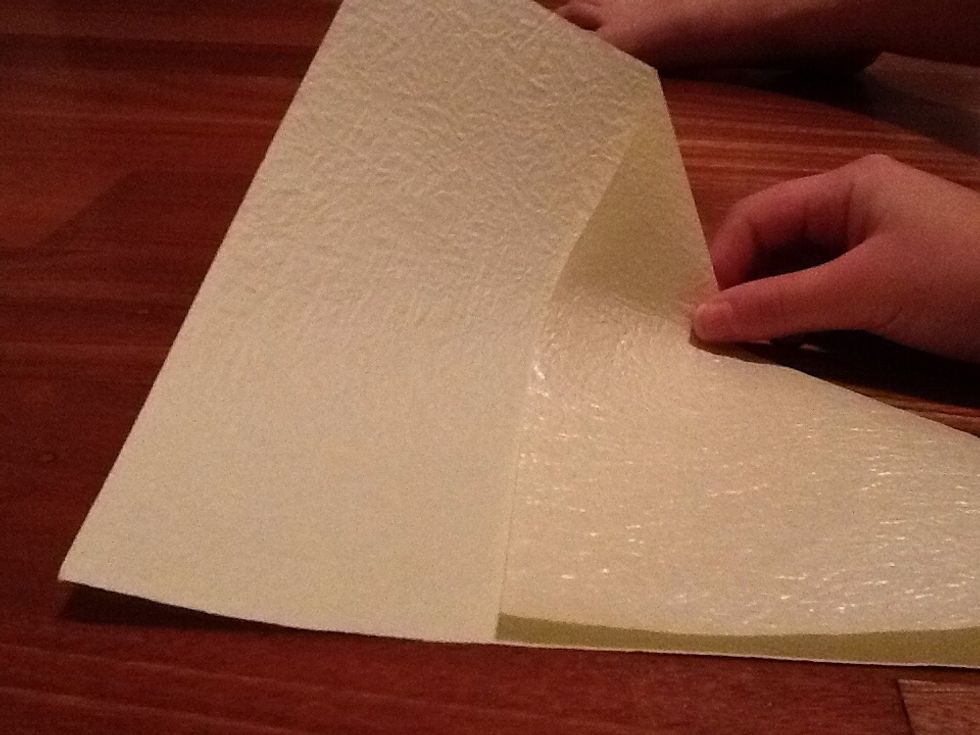If you have a rectangular piece of paper, fold your paper diagonally and cut the extra bit of the end. If you already have a square piece of paper then skip this step.