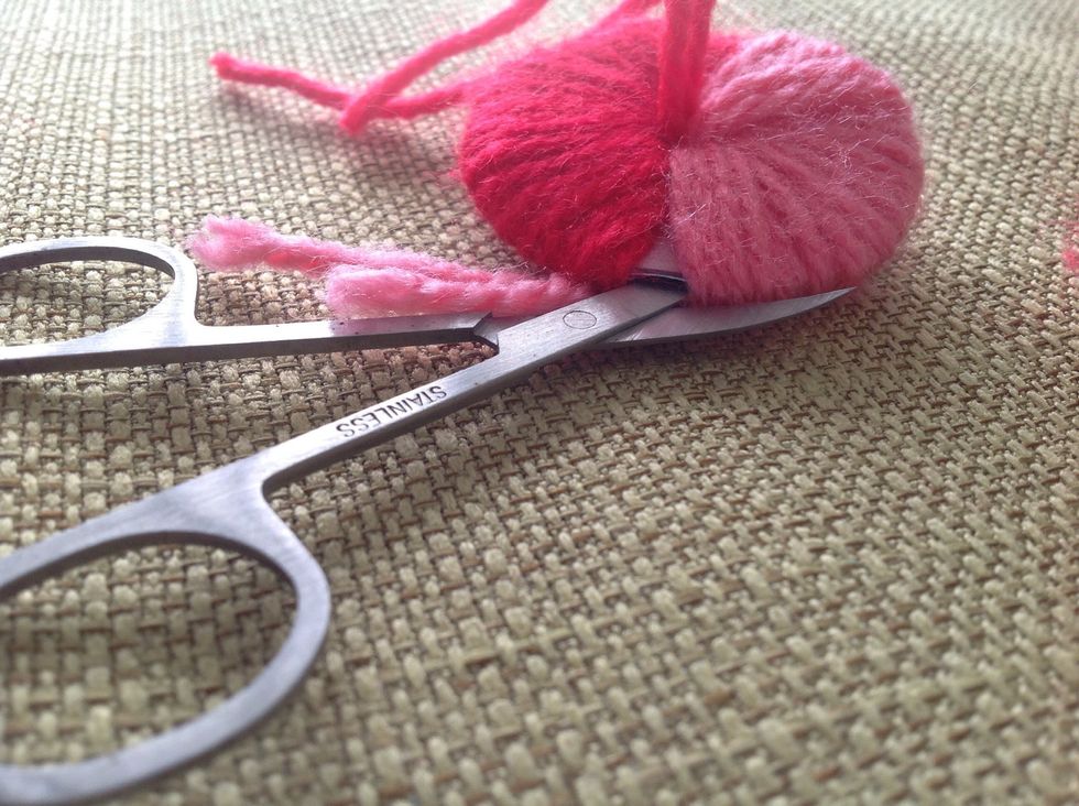 If you have a small scissor, you can use it and cut from there, so your Pompom will be round, but normal scissors work just fine for this.