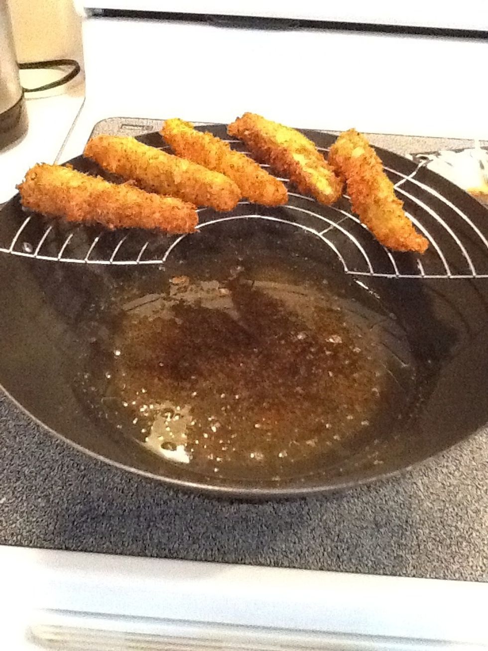 If you have a strainer, place fried pickles here after they are brown and crisp. Otherwise, transfer to a plate covered with a paper towel to absorb any excess oil.