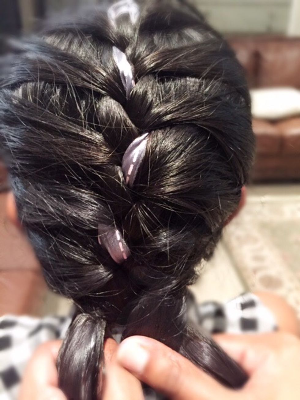 If you have any excess hair once you have reached the end of your head, divide that hair equally into your three sections.