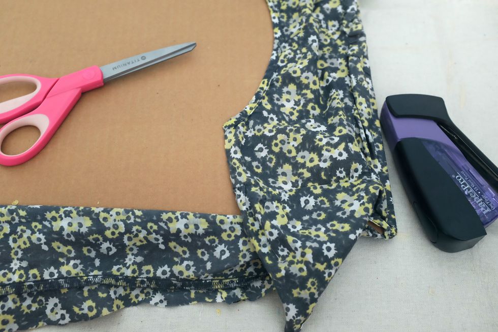 If you have to use multiple cork tiles, don't worry about centering the seams. Take fabric and cover the front, turn the whole thing over, and staple in place. Be sure to pull the fabric taut.