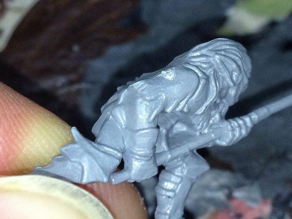 If you look at this model, you'll notice a number of things. First come the mould-lines. These are easy to trim, but the place where you severed it from the sprue is the first thing you must soften.