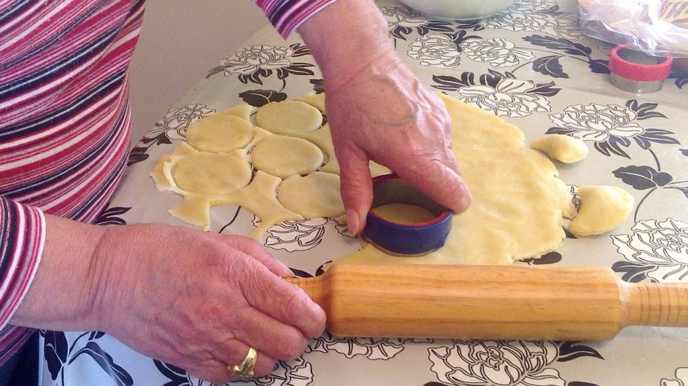 If you look carefully, you can see the black floral pattern under the dough. That's perfect. Cut all your dough into 6-8 cm circles. The balance dough, reform and roll again.