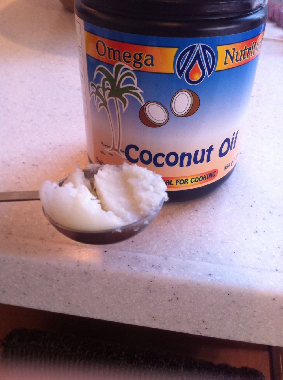 If you only have coconut oil in the solid form (like me) then you want to melt it into its liquid form. So gather 1 tbsp. of solid coconut oil...
