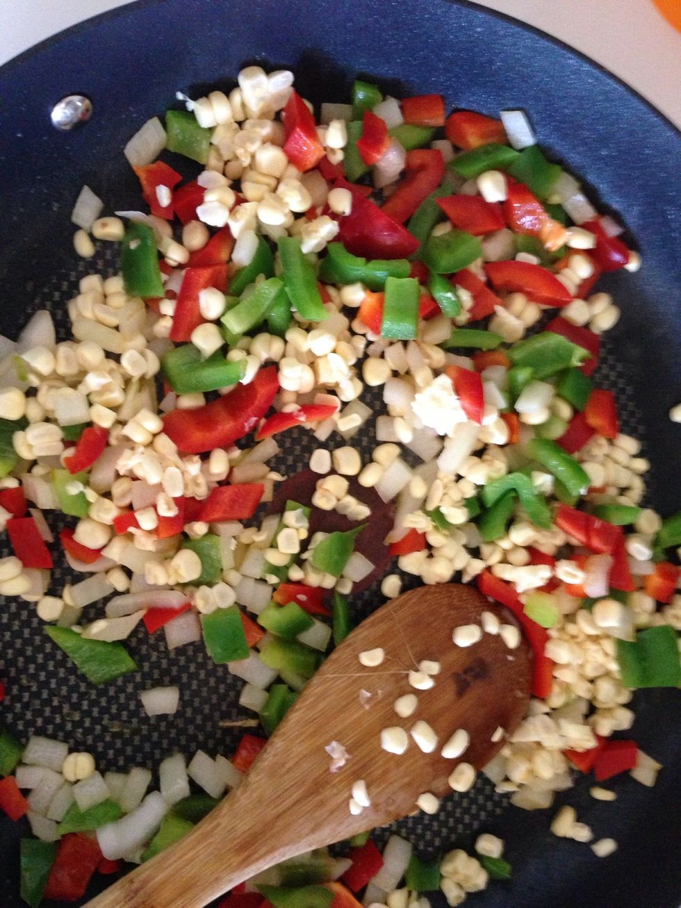If you're using a fresh cob, using a knife take off the corn kernels and add them to the pan. Otherwise just just add half of a can of corn to the veggies.