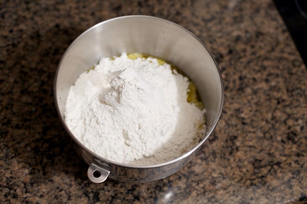 If you're using a mixer, add all 5\u00bd cups of flour at once.  Otherwise, add the first 1\u00bd cups, mix well, then mix in the rest half a cup at a time.