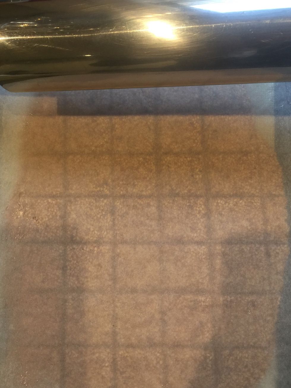 If you want squares...Cover with wax paper and spread with a rolling pin. Make indents in the shape desired. When it is cold.. The shapes will snap where it was marked.