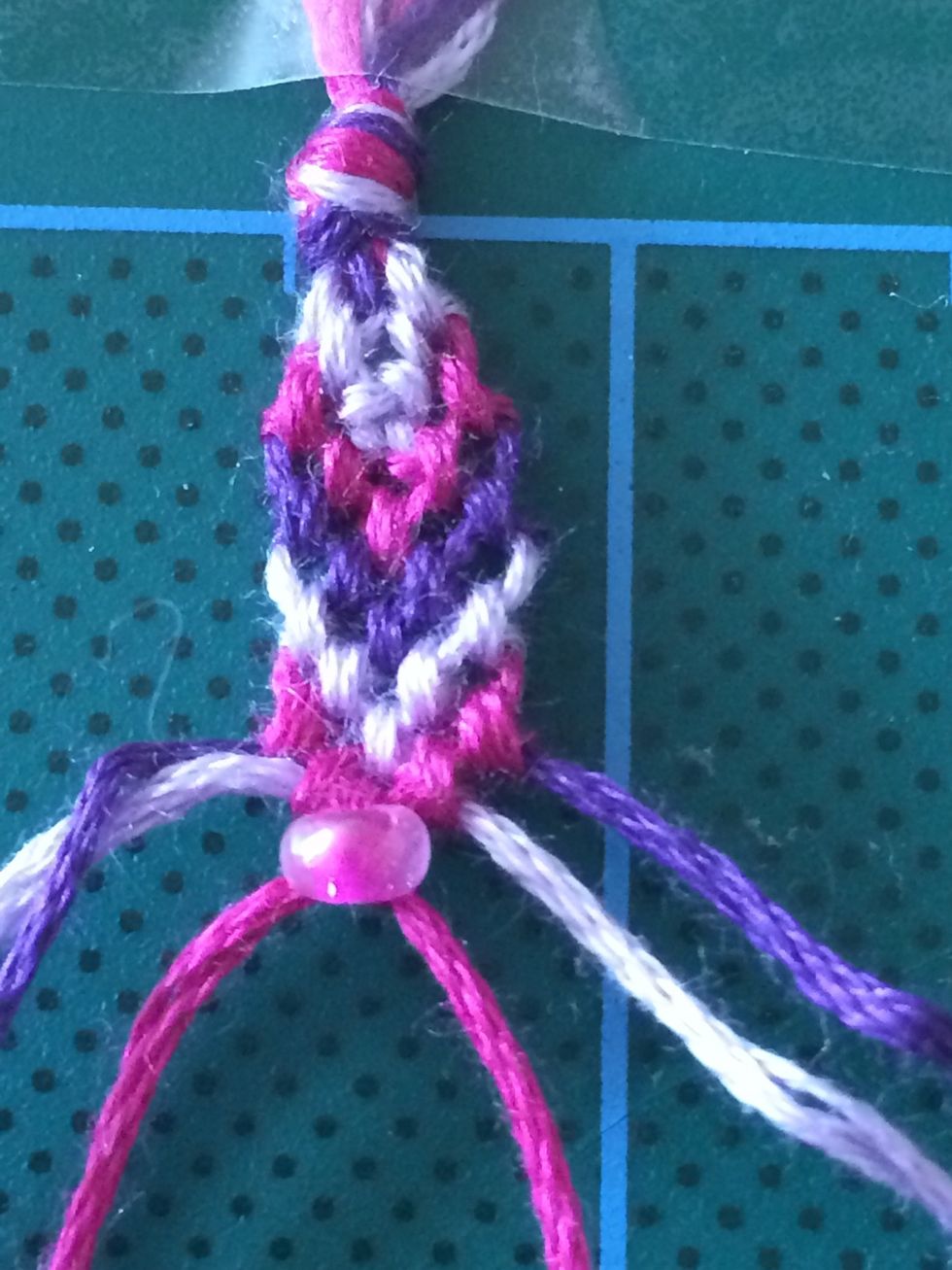 If you want to add a bead, create a knot in the centre, then feed the bead through one of the centre threads and create the double knot.