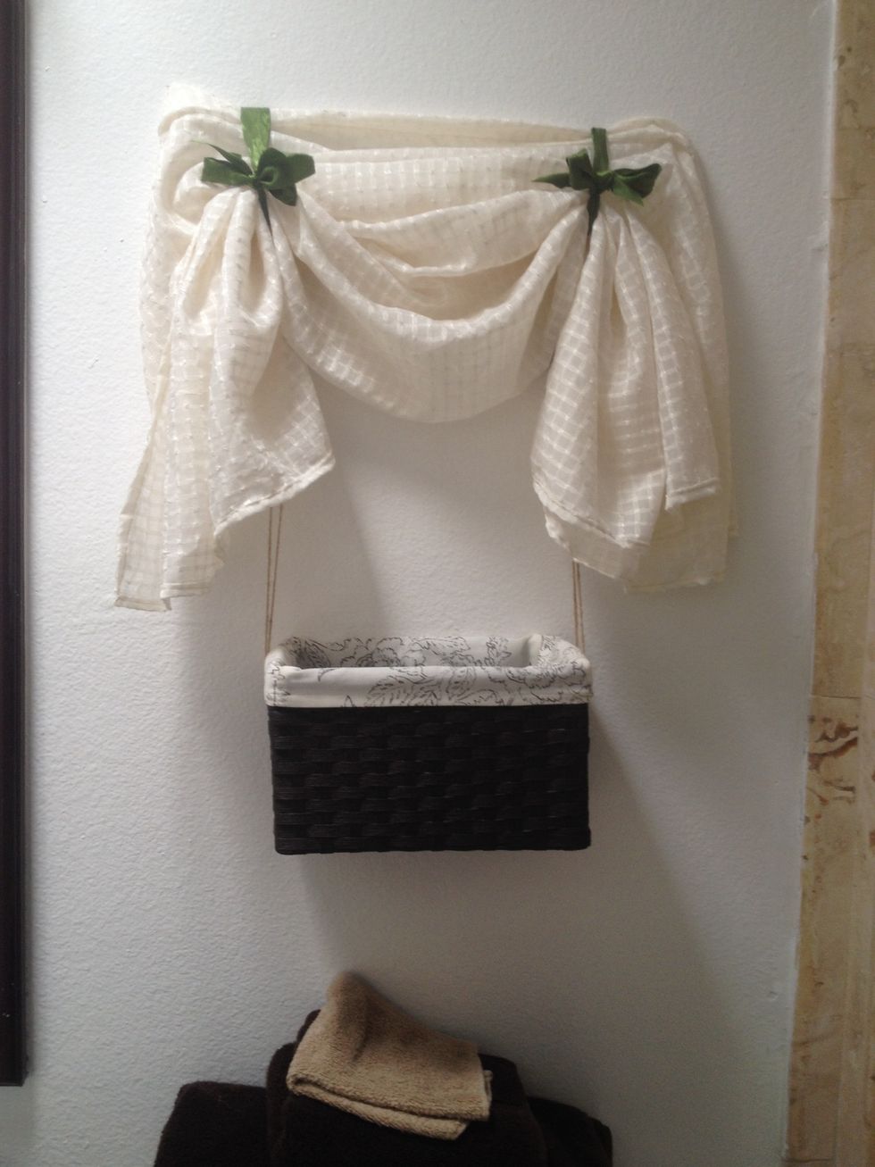 If you want to hide the hooks, hang a light piece of fabric above and tie it with ribbon about 6 inches above the hooks.
