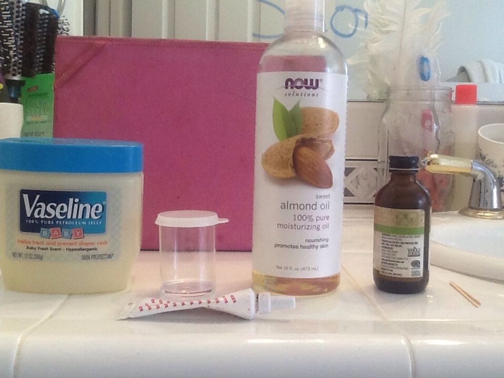 If you want to put your gloss in a container with a wand, scoop the gloss into a plastic bag and cut a hole at the tip, like you would do for icing. Squeeze it in and close the lid.