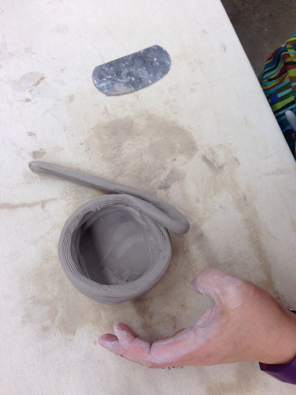If you want your pottery to curve inward, place the coils on the inner edge of the pot.