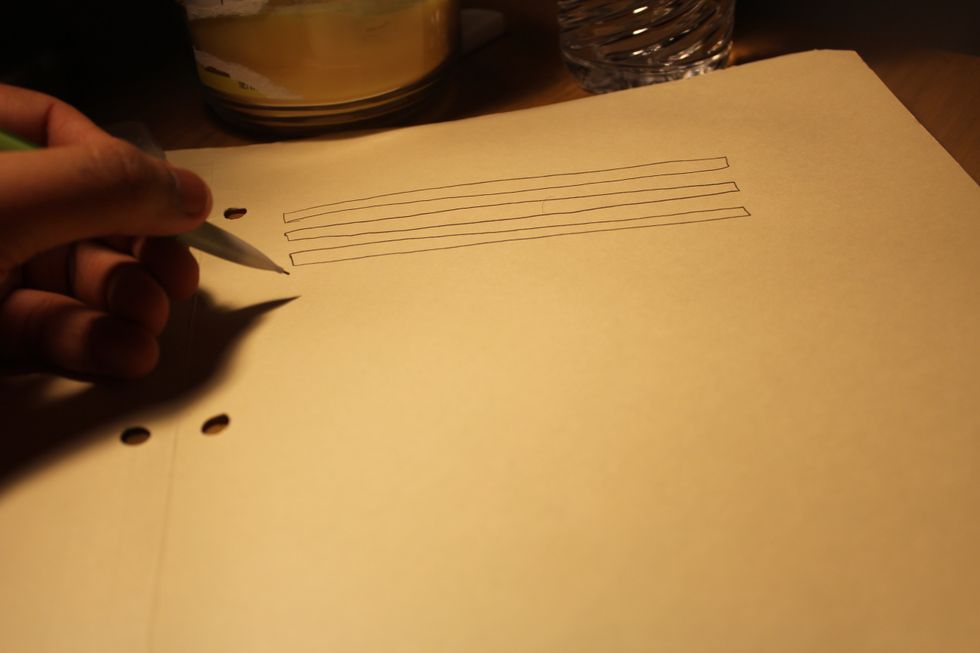 If you were to make a window, using your pencil, draw about 5-6 long rectangles on the construction paper.