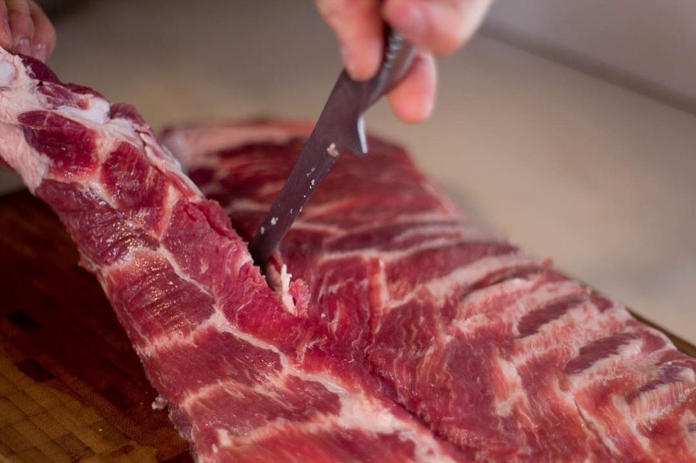 If your ribs are still whole, cut off the bottom section just under the rib bones. Your knife should cut through the cartilage easily. After its removed, cut it into smaller portion sizes.