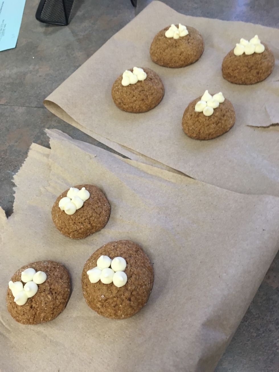 iimmediately press a couple of white chocolate chips into center of each cookie