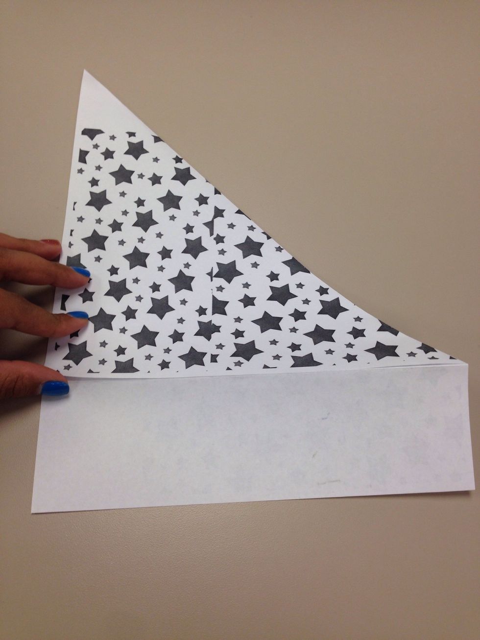 Im making a square here by taking the excess paper off