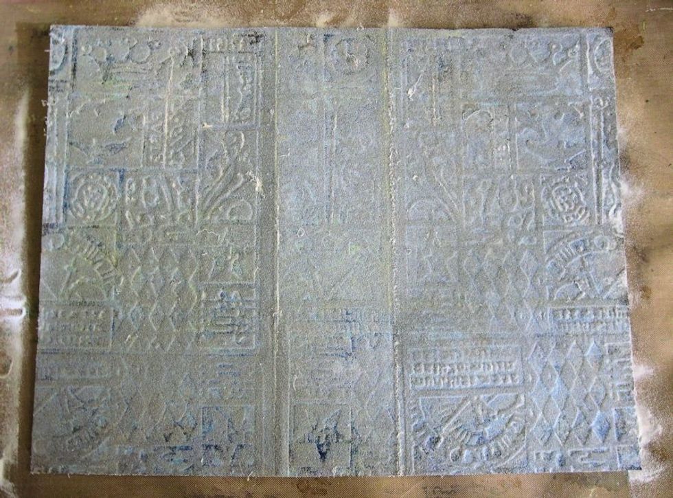 Immediately after inking, cover the entire surface with clear embossing powder. Very gently tap off the excess, but remember that you want a thick coating if possible.