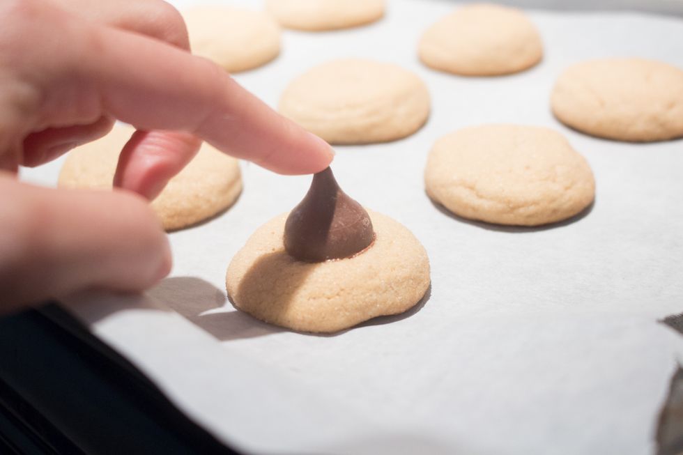 IMMEDIATELY put the hershey kiss chocoaltes on top.