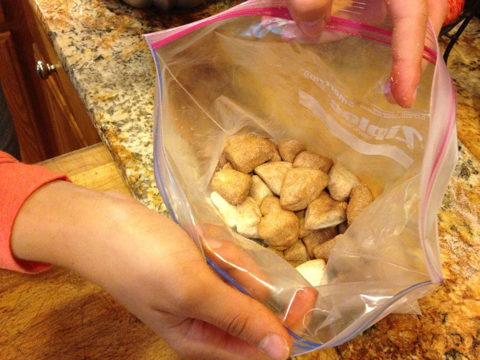 In 2 batches shake the biscuits in the sugar mixture.