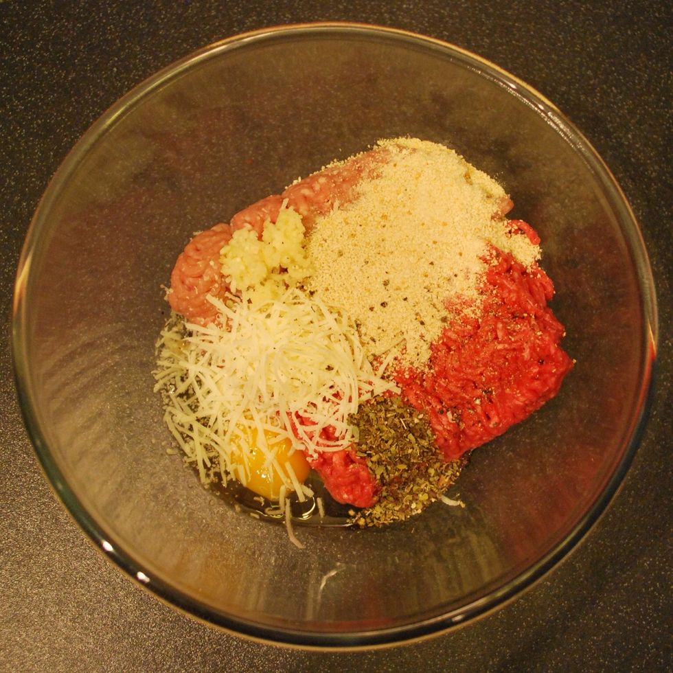 In a big bowl add: beef and pork mince, egg, Parmesan, 2 crushed garlic cloves, breadcrumbs, 1 tsp oregano and salt and pepper