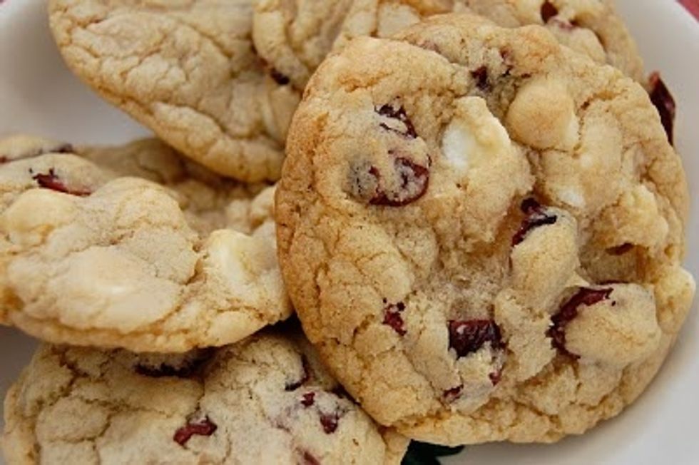 in a big bowl whisk together butter, white sugar and brown sugar beat in 2 eggs one at a time. then add almond extract and vanilla extract