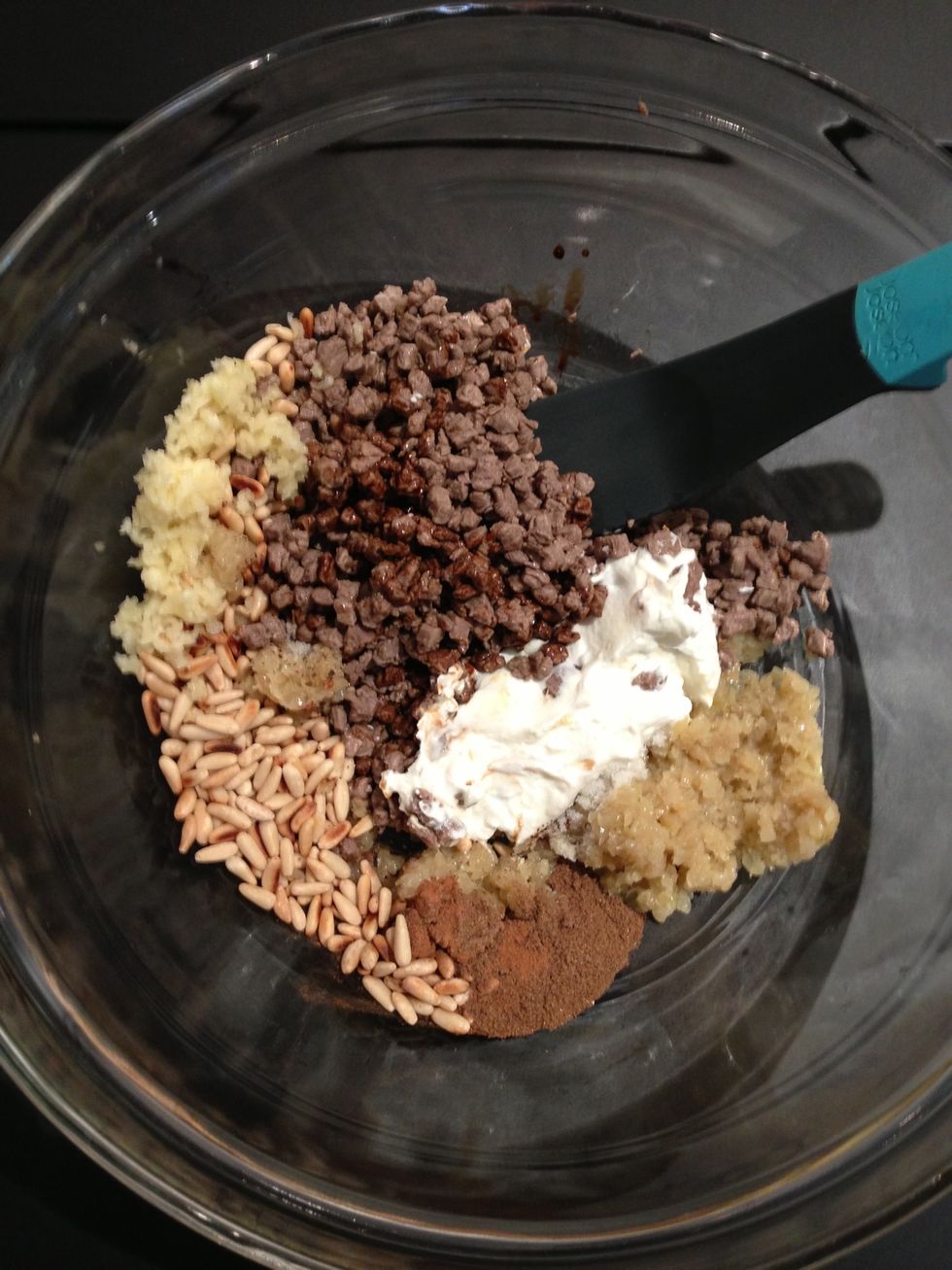 In a big mixing bowl put the cooked onions, the half cooked meat, the grilled pine seeds. The spices the 2 TBsp of yogurt, salt,. Taste and adjust.