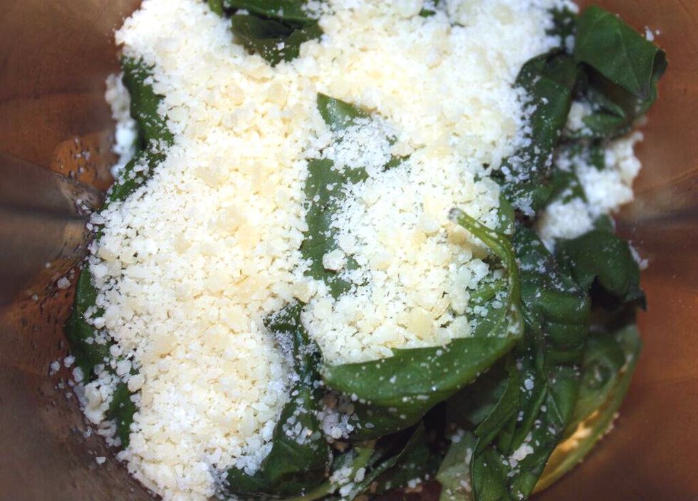 In a blender, add the basil, spinach, garlic, lemon juice, and parmesan cheese.