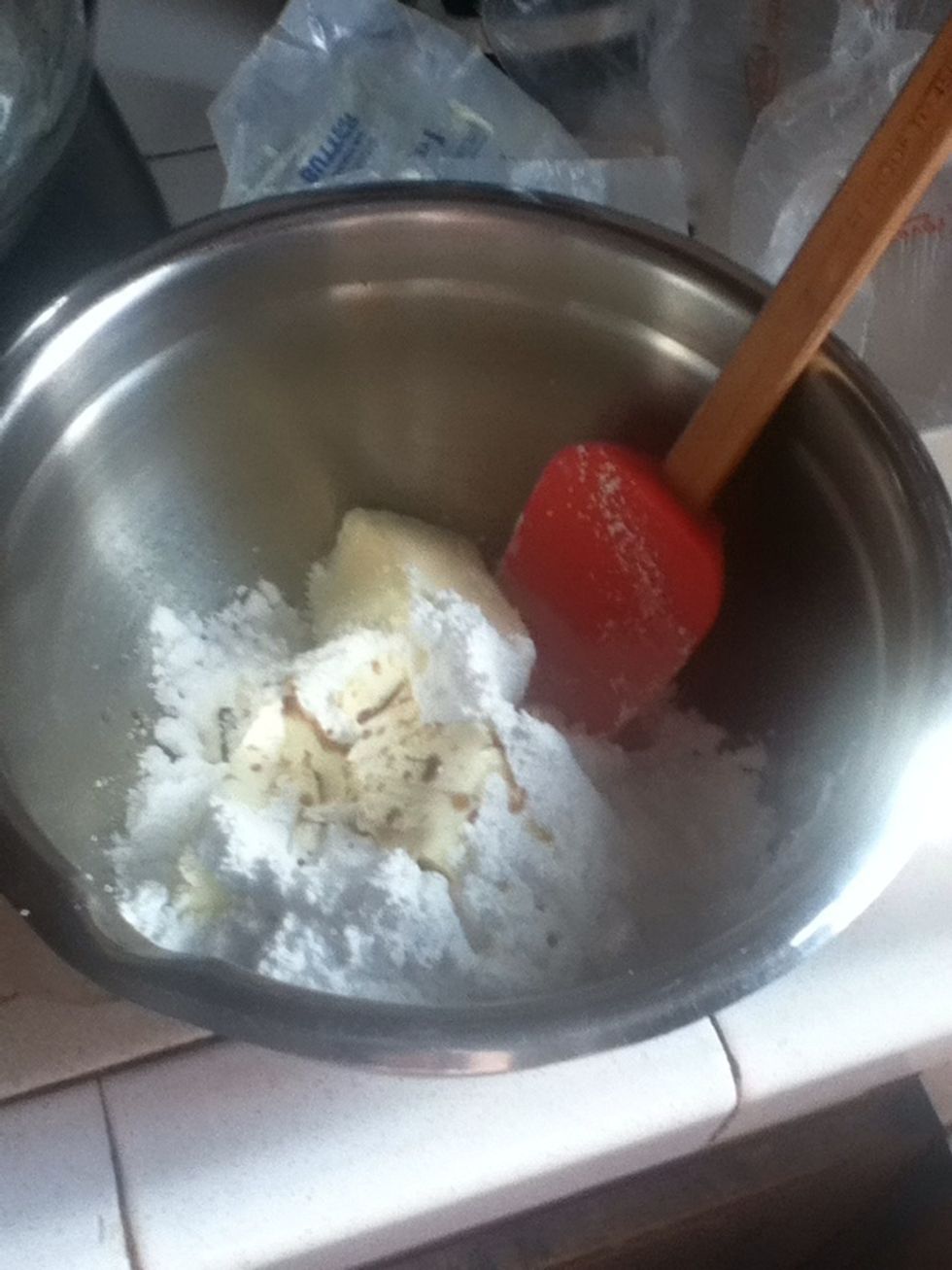 In a bowl add your butter softened have it a couple of hours  in room temperature or 15 seconds in the microwave. Add your 3/4 cup of powdered sugar and you vanilla extract and pecan extract.