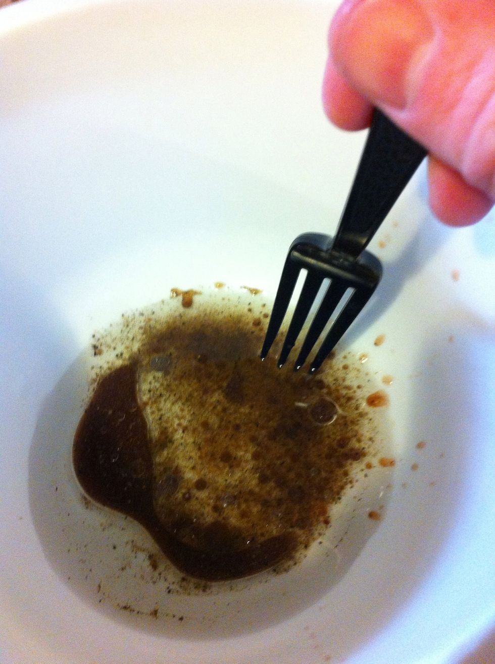 In a bowl, beat 2 tablespoons canola oil, 1 tablespoon vinegar, 1/4 teaspoon salt, and 1/4 teaspoon black pepper together with a fork.