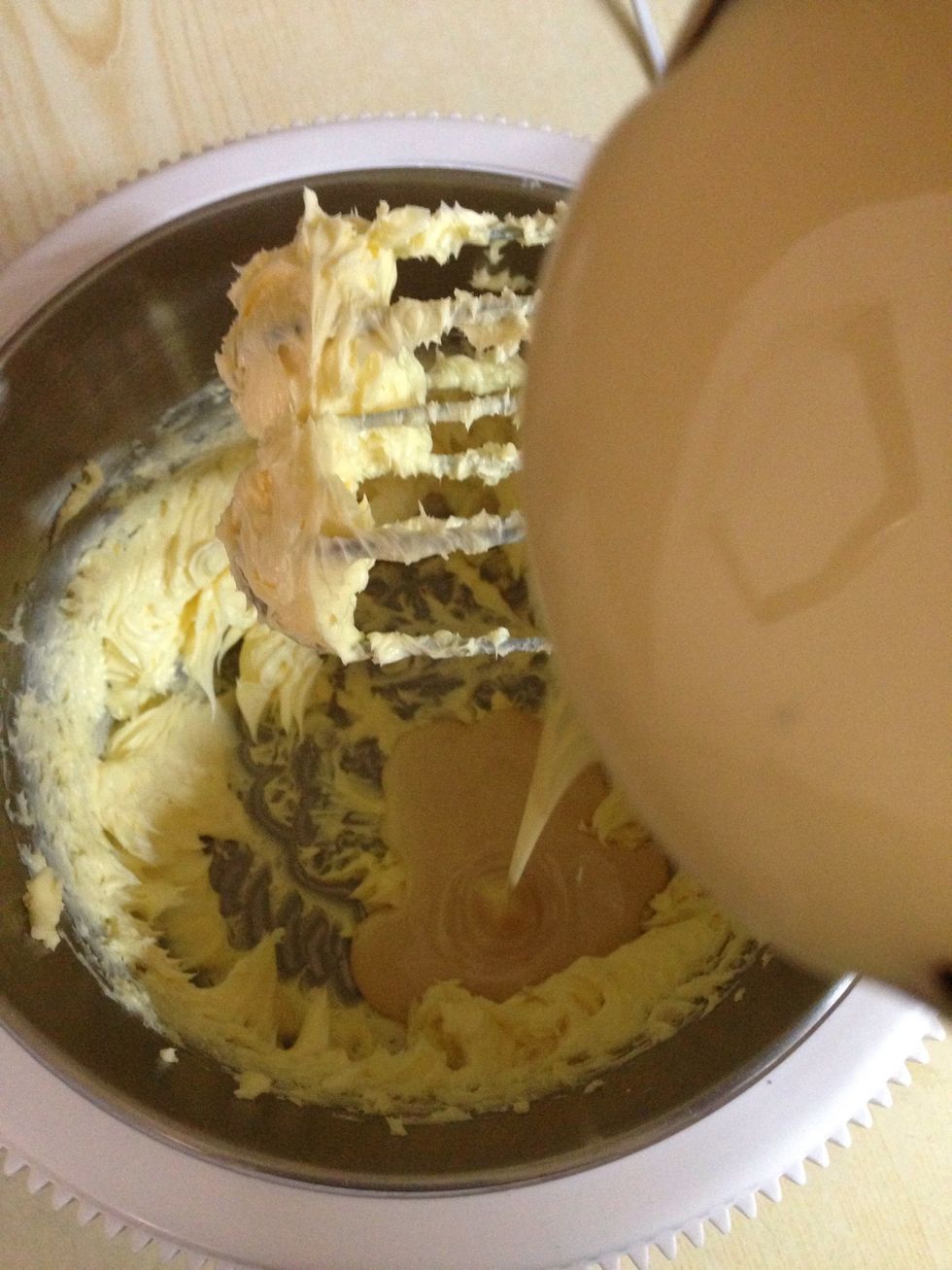 In a bowl beat 200 butter until pale, and gradually add 1 can of condensed milk