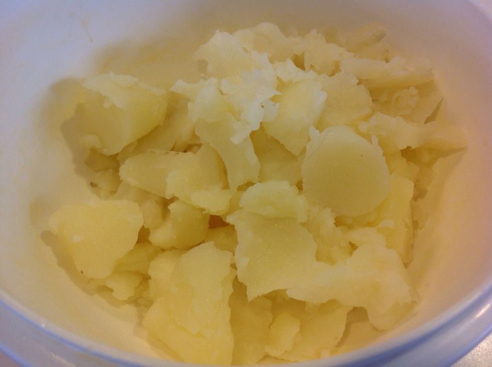 In a bowl, mash up the scooped out potato.