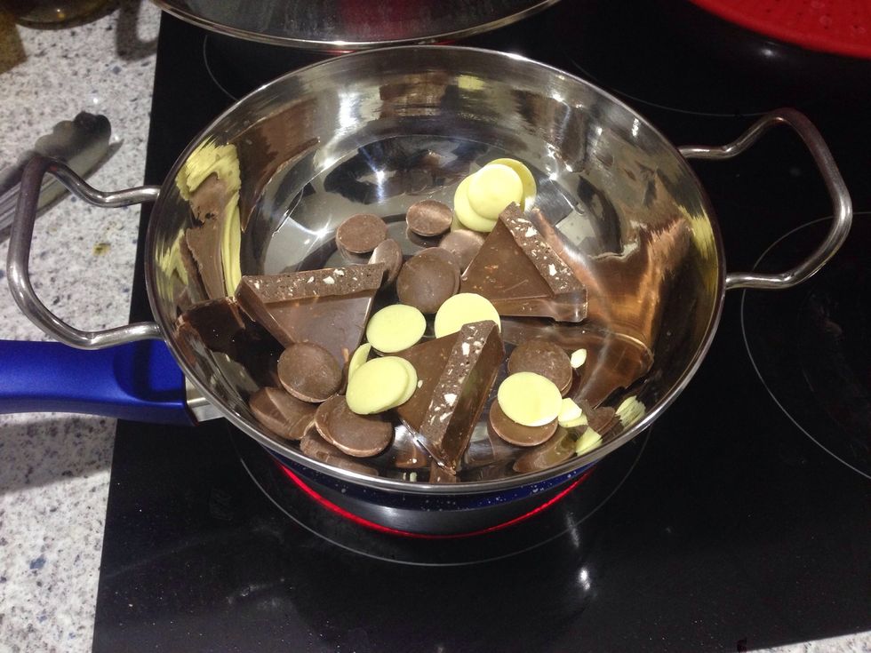 In a bowl on top of boiling water, add 5-6 bars of tobelerone and a few pieces or dots as I have of dairy and white chocolate and melt.