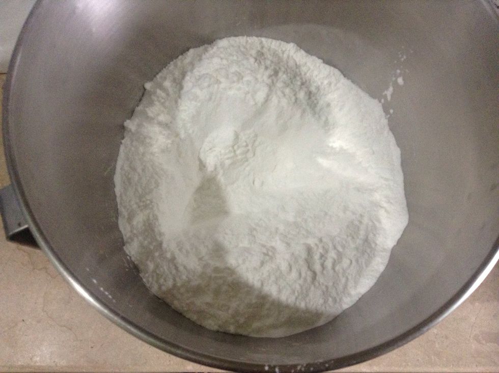 In a bowl , place 4 cups of confectioners' sugar, make well. Poor the lukewarm gelatin mixture into the well and stir with a wooden spoon, mixing sugar & adding nore, a little at a time, >>>>