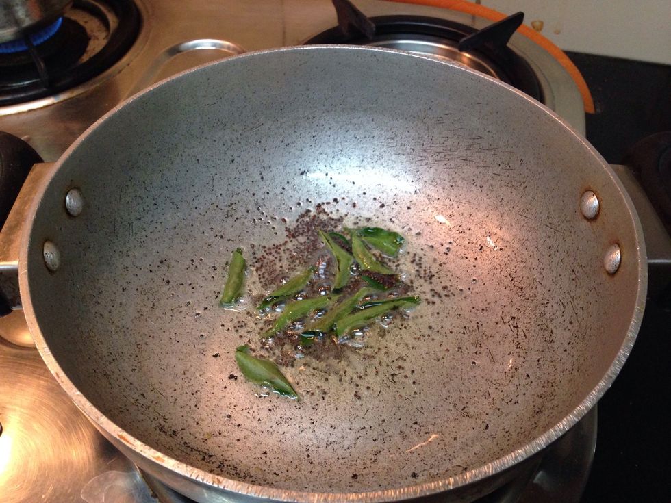 In a bowl vessel, add oil, mustard seeds and curry leaves on a medium flame.