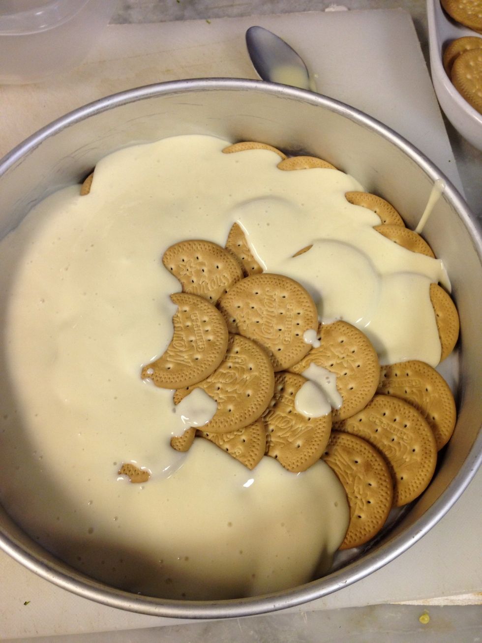 In a cake pan place a layer of cookies and a layer of the mix i took the picture half way because i forgot to take the pic with just the cookies. Sorry   It works better in a square or rectangular pan