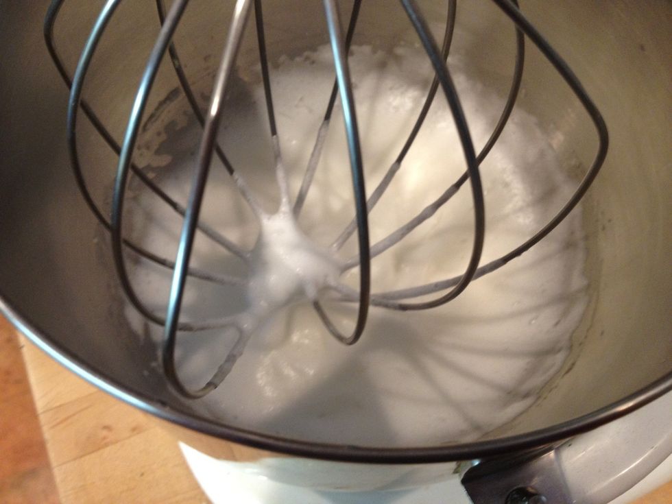 In a clean bowl, using the whisk attachment, beat the 2 egg whites with the remaining sugar. Soft peaks will form.