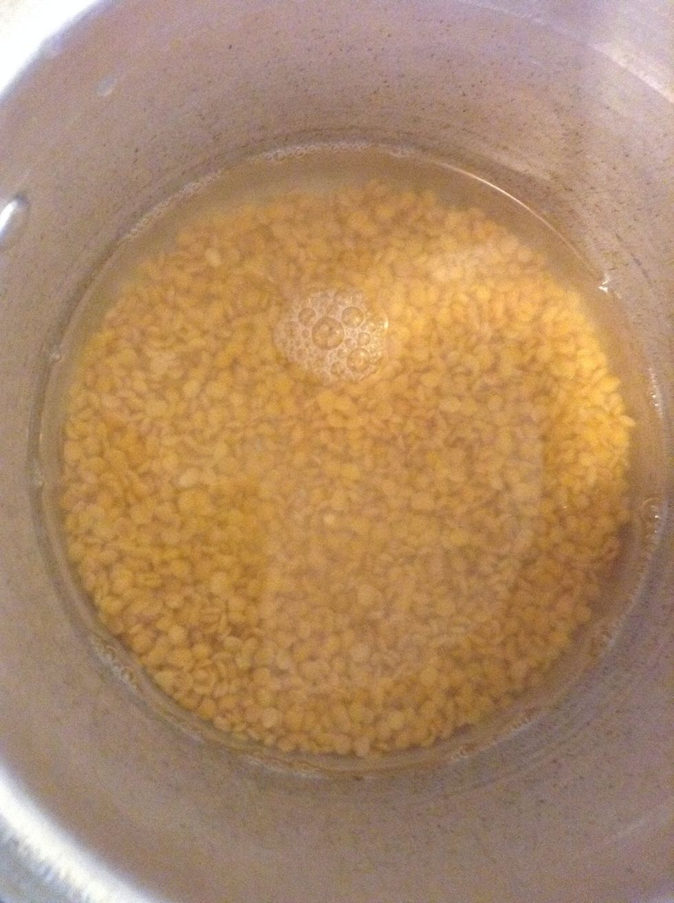 In a cooker, take the Toor Dal. Add equal measure of water to it and cook well.