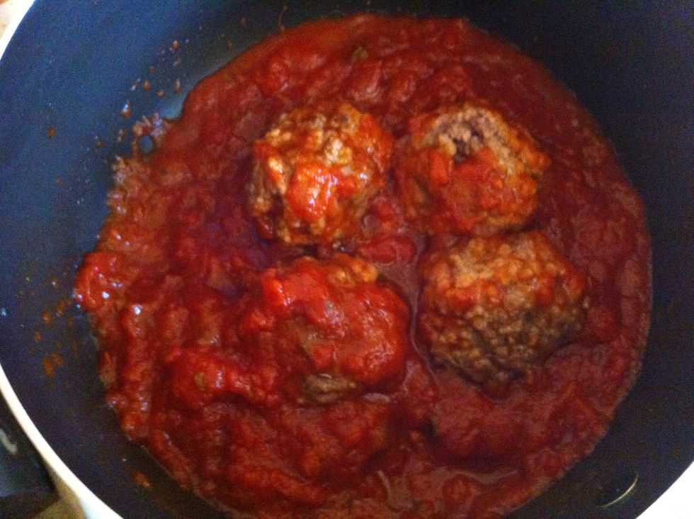 In a cooking pot, stir the spaghetti sauce with some salt & pepper, and add the meatballs. Cook for about 5 minutes.