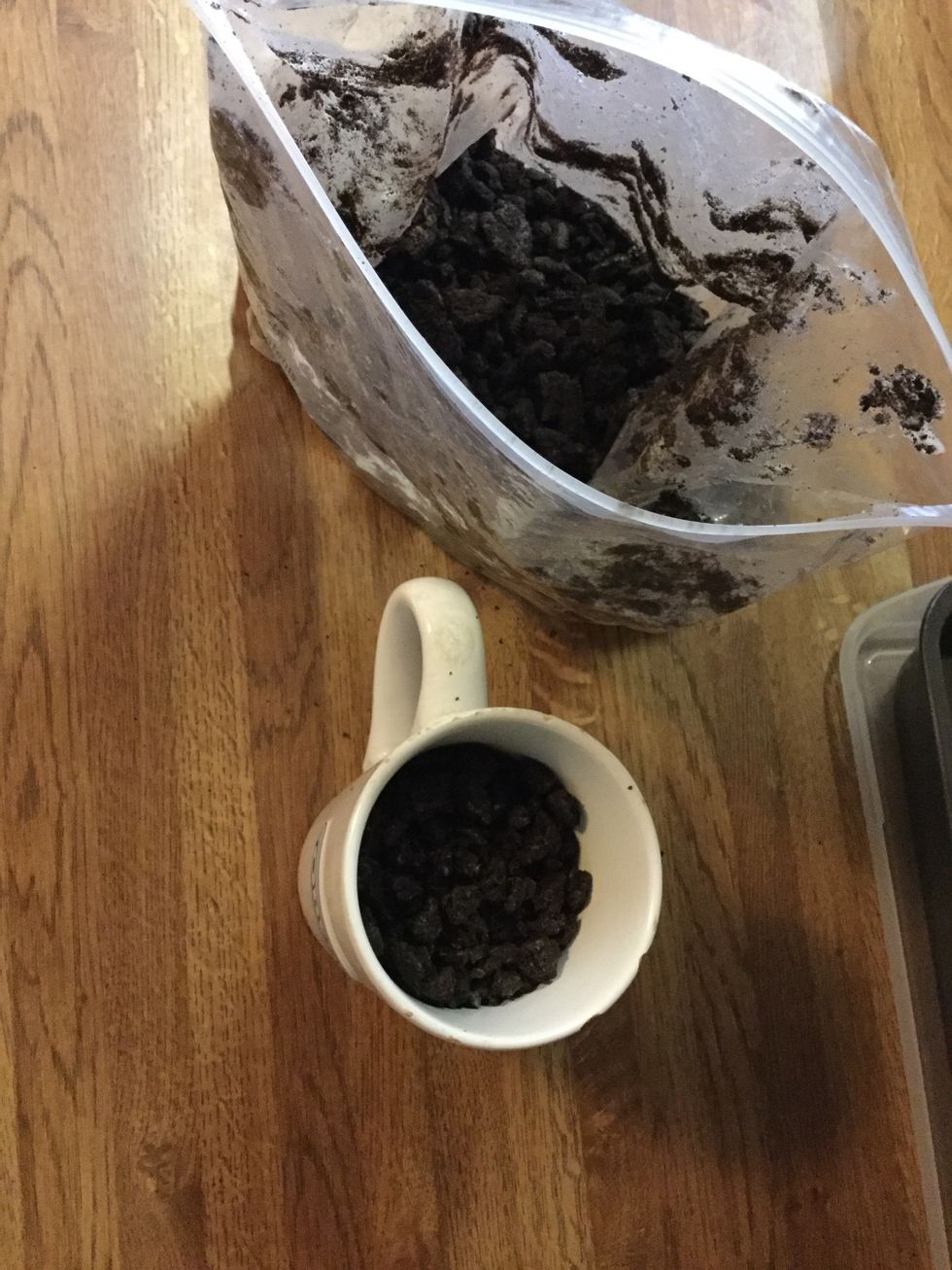 In a cup, set aside 1 cup of crushed Oreos.