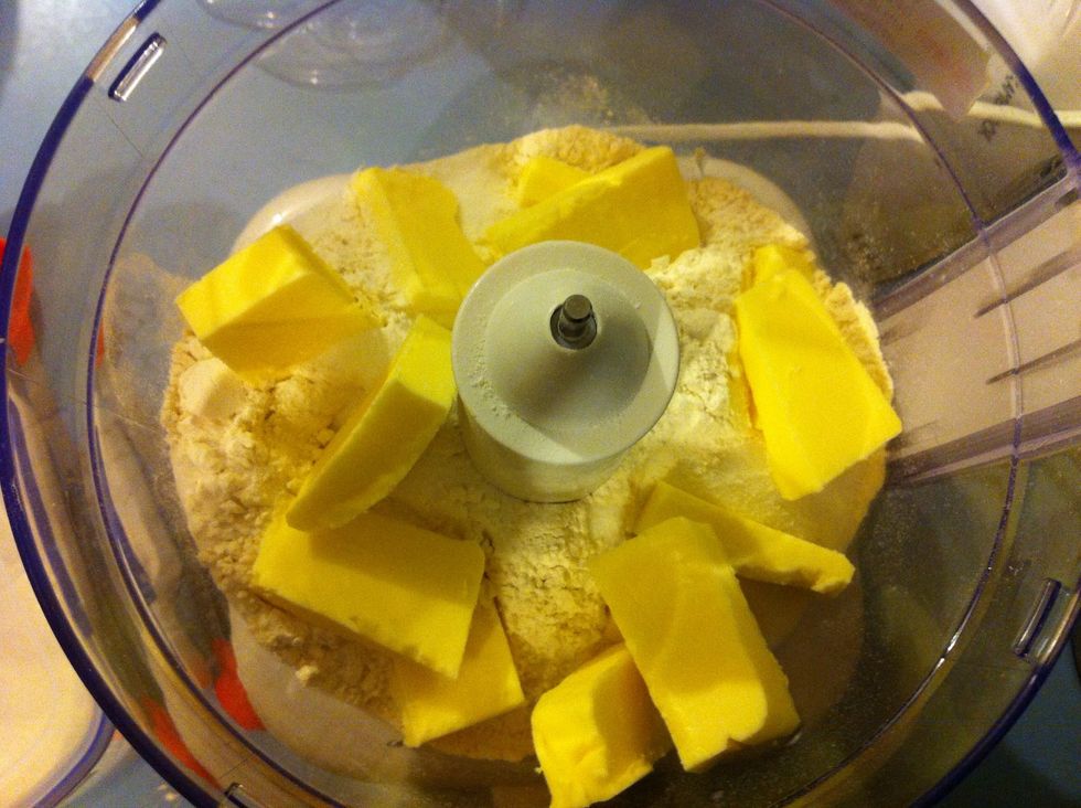 In a food processor, process the flours, salt, butter and sugar. Once done, add the yolk and water and process again until the pastry is starting to come together.