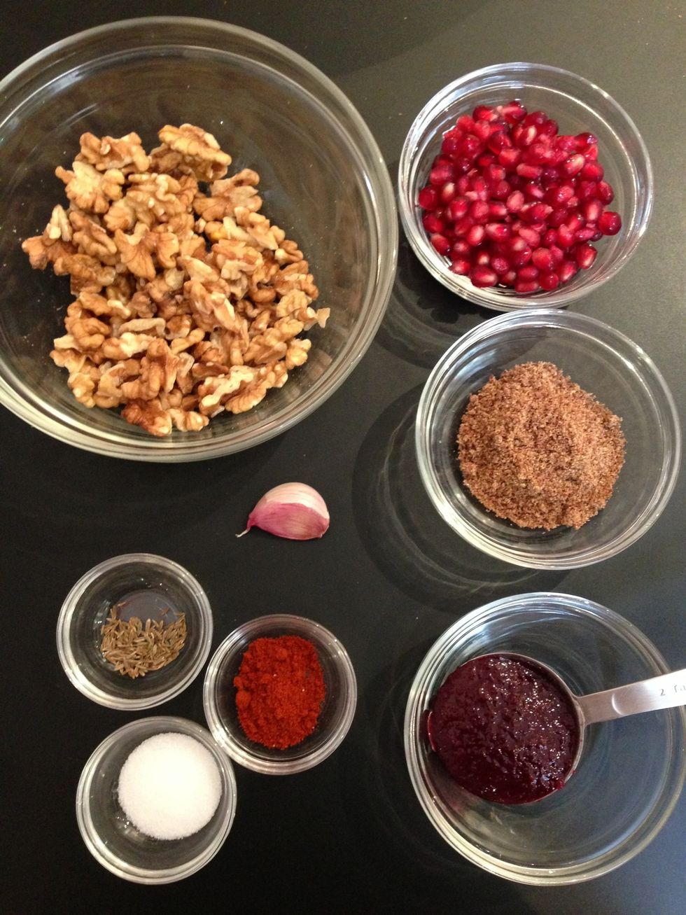 In a food processor, Put grilled bell peppers + walnuts+1 garlic+2TBsp ground flaxseeds+salt, paprika and cumin+2TBsp pomegranate molasses . And reduce them to a coarse paste or finer. Done. Serve