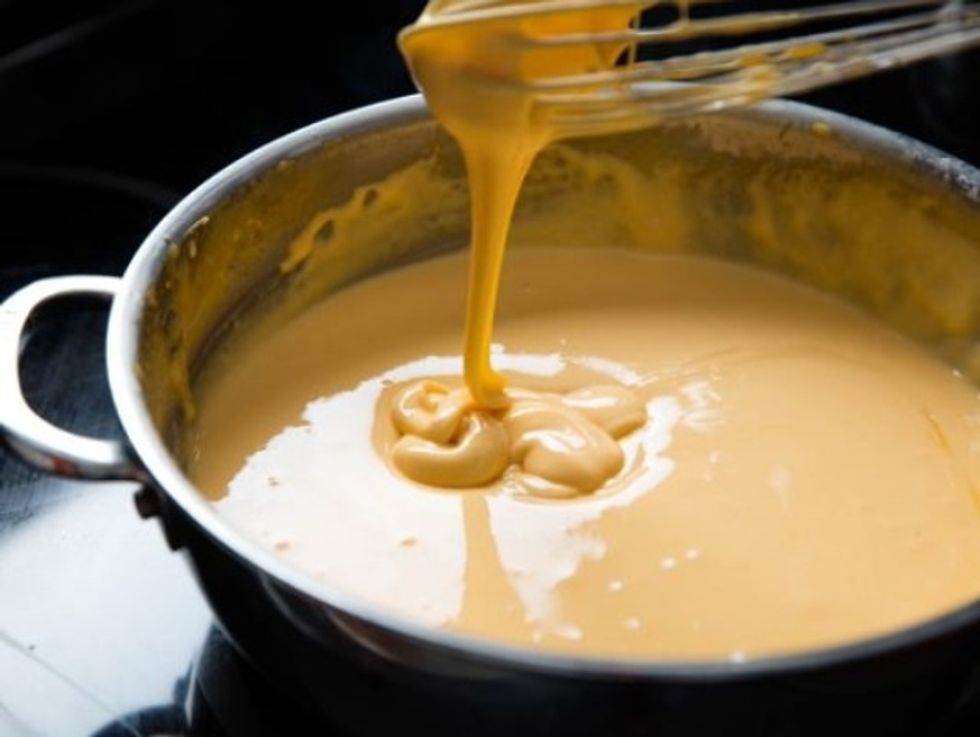 In a hot pot, pour the milk and butter in. Add in the flour, salt and pepper. After all, add in the cheeses.