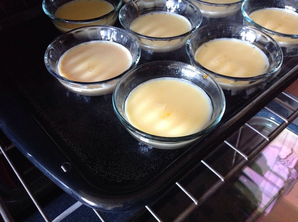 In a large baking dish, pour 1-2 inches of water and place the cups in it.