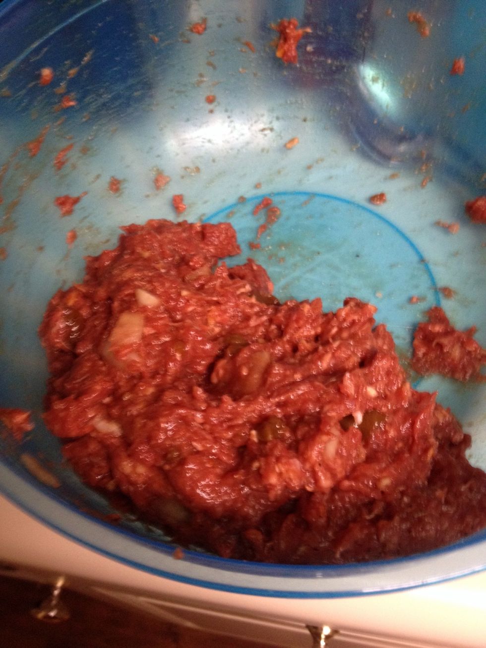 In a large bowl combine your beef, beef stock, seasoning, worcestershire sauce and onion soup mixture. Make sure to add water to the onion soup. Stir until everything is nicely combined.