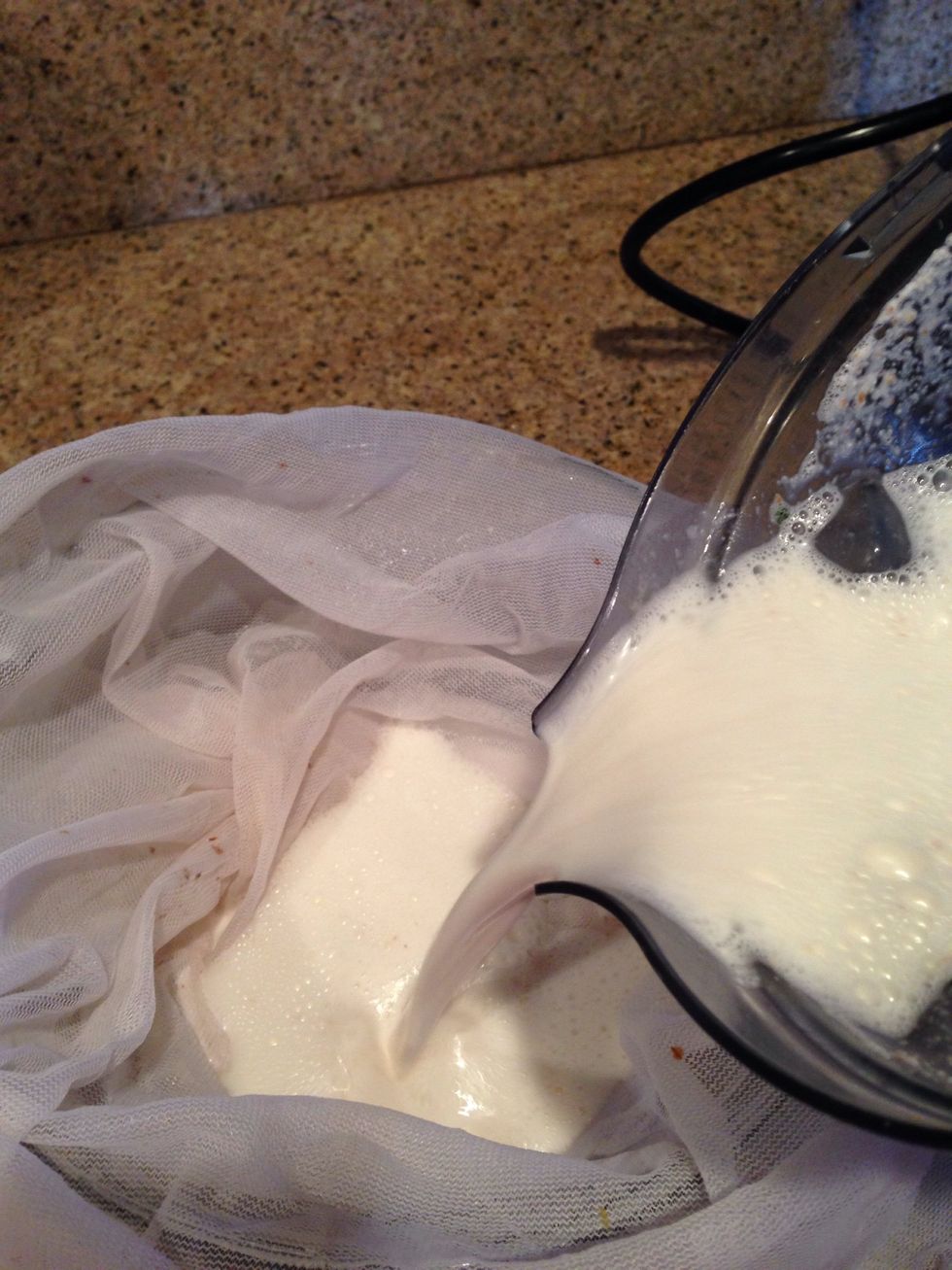 In a large bowl, lay your cloth strainer out and pour your mixture in. Most of the liquid will drain into the bowl.