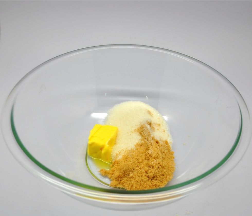 In a large bowl, mix butter and both kinds of sugars.