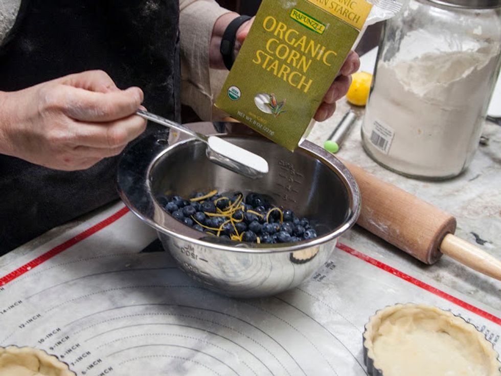In a large bowl mix together the blueberries with the lemon zest.