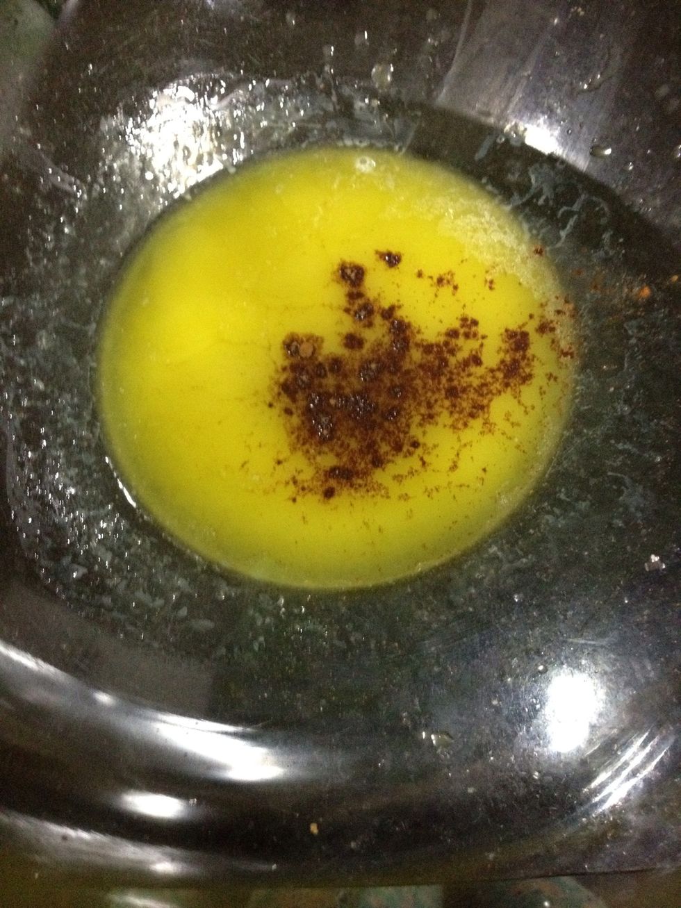 In a large bowl, place the melted butter and cinnamon. I'd really encourage you to use the cinnamon - its not even strong cause we use so little but, if you really don't like it, you can skip it. \ud83d\ude33