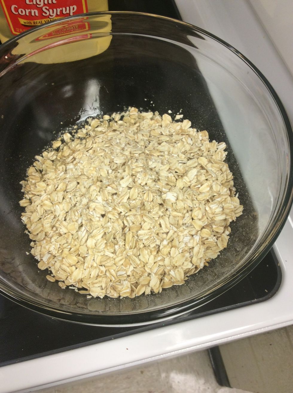 In a large bowl stir together vegetable oil and oats.